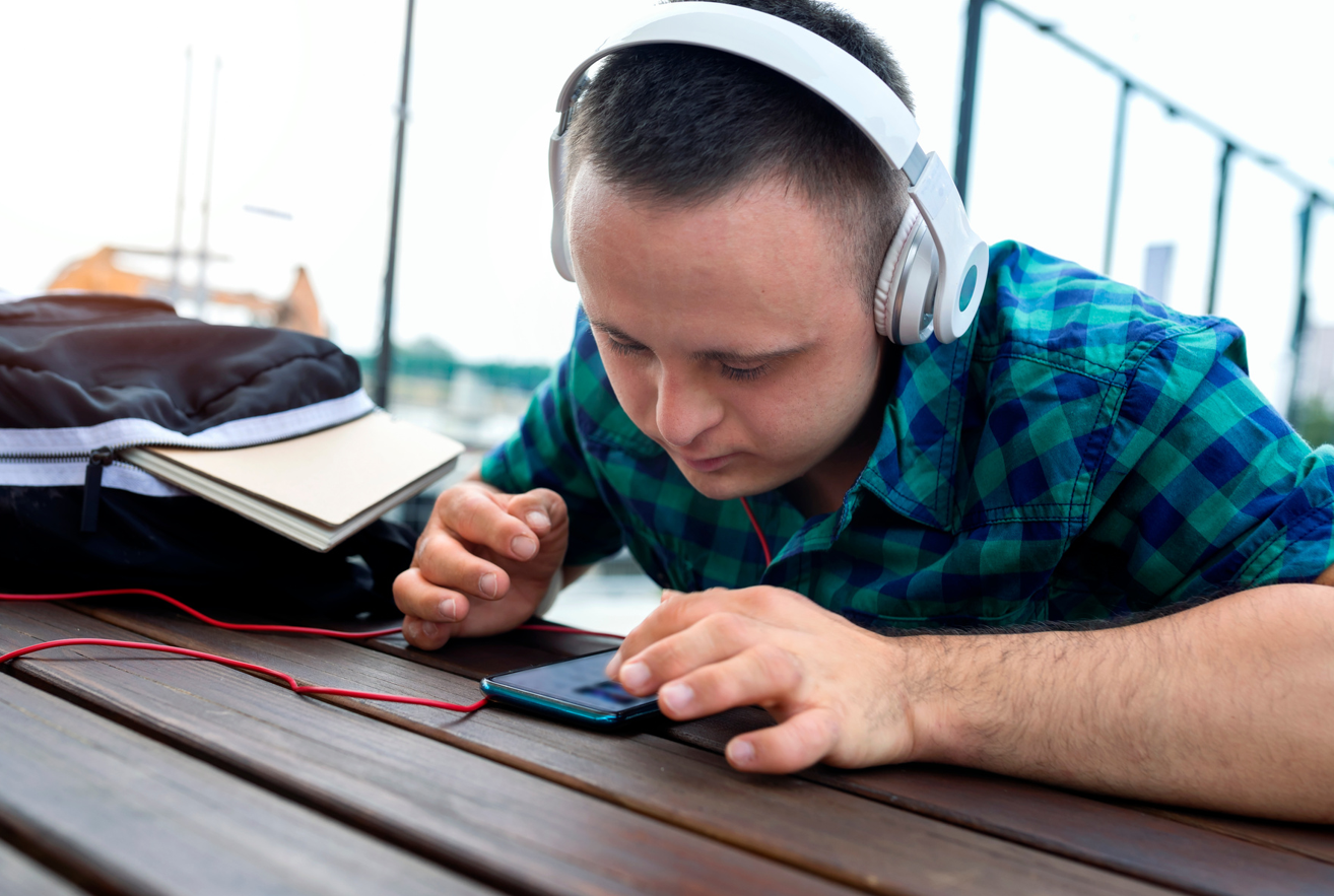 young-man-using-mobile-device-on-a-table