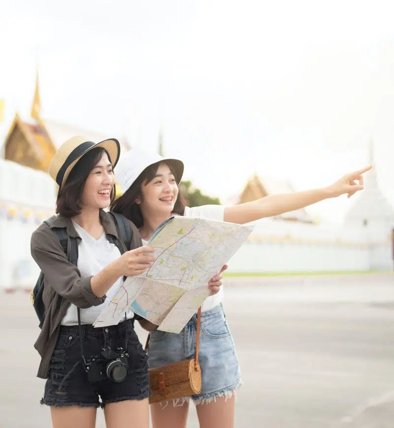 smiling-travelers-holding-map